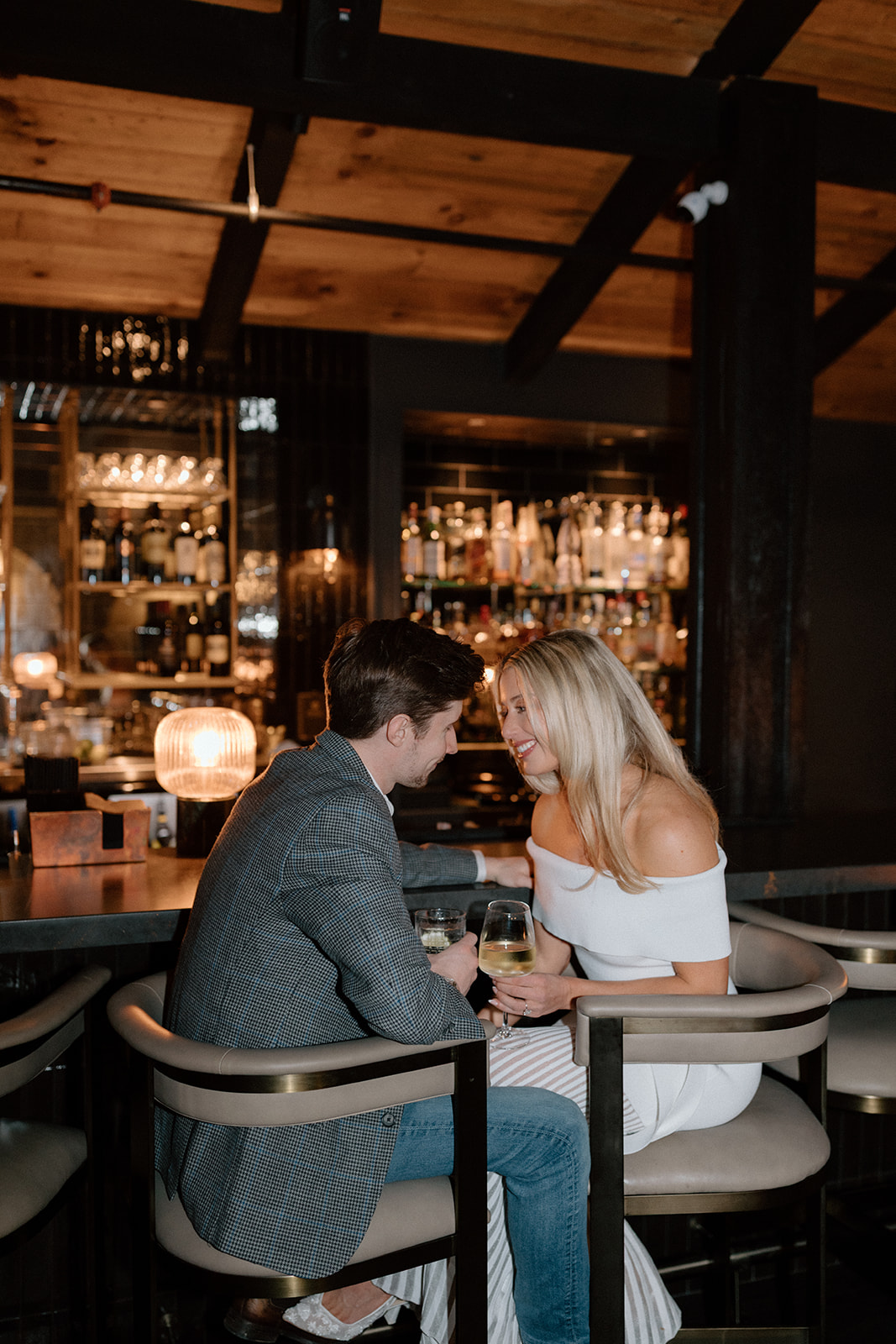 A couple shares a quiet moment at the Smoke & Timber bar
